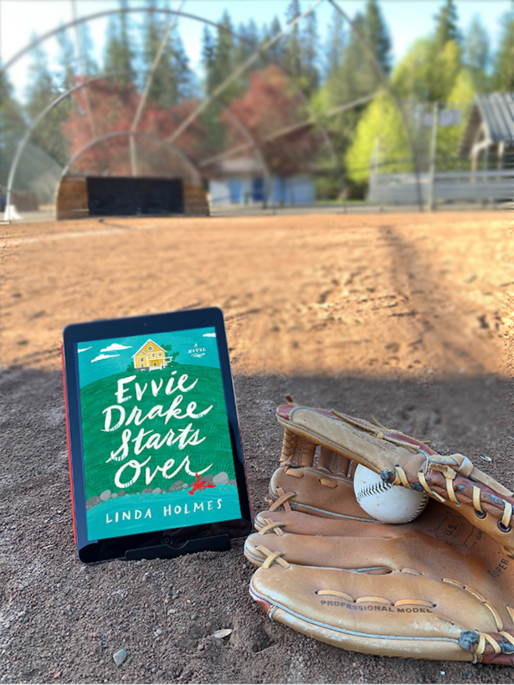evvie drake starts over ebook sitting next to a baseball and glove, with a baseball backstop in the background.