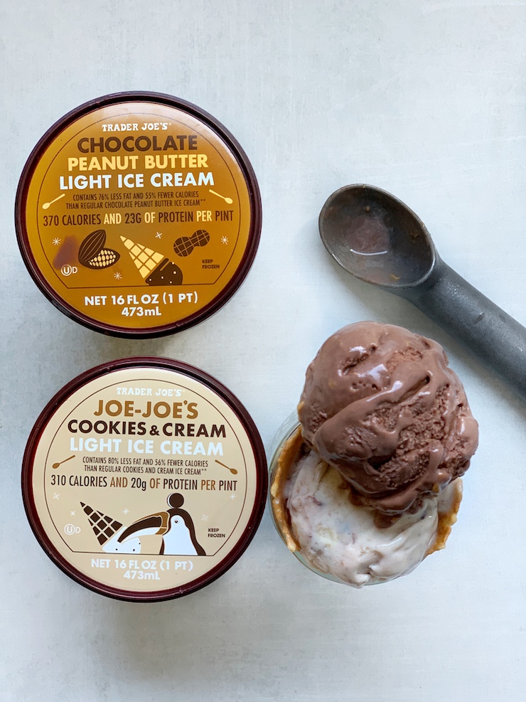 Trader Joe's Light Chocolate Peanut Butter and Cookies and Cream ice cream cartons next to a double scoop in a cone, viewed from the top.