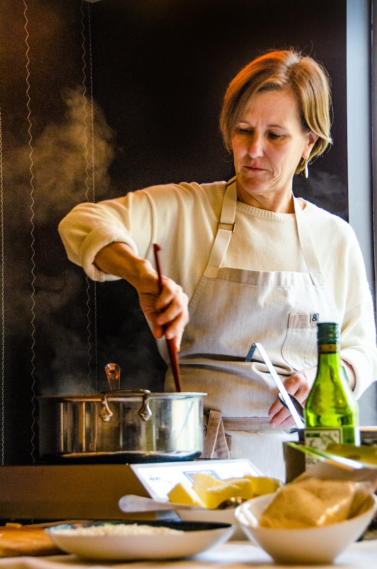 Chef Holly Smith stirs a pan of risotto mantecato with pecorino toscano.