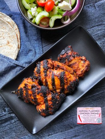 Grilled Trader Joe's Harissa Chicken Thighs on a black rectangle plate