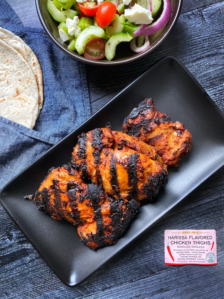 Grilled Trader Joe's Harissa Chicken Thighs on a black rectangle plate
