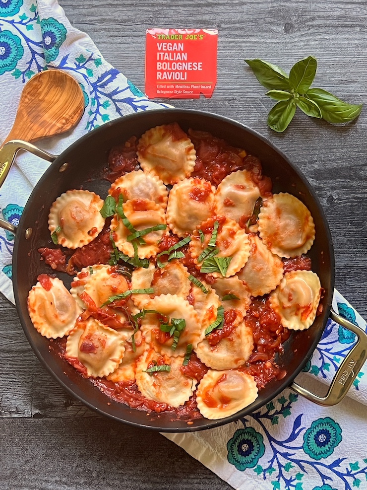 Trader Joe's Vegan Italian Bolognese Ravioli as prepared in a nonstick pan with tomato sauce and topped with basil.