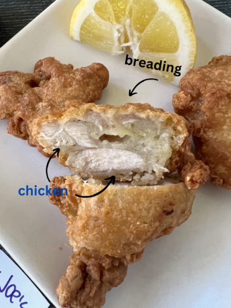 Cross section of another piece of karaage showing the thick breading vs chicken.