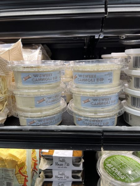 Trader Joe's Sweet Cannoli Dip containers in the refigerated section of a trader joe's store.