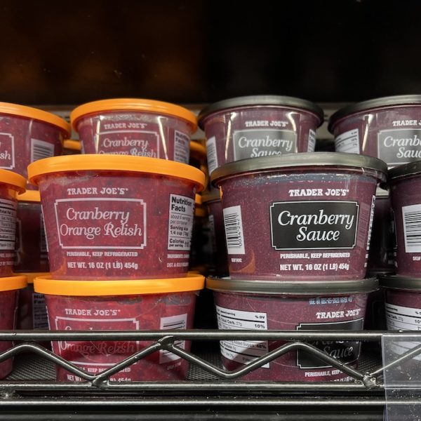 Trader joe's Cranberry Orange Relish and Cranberry sauce on shelves in the rerigerated section. 