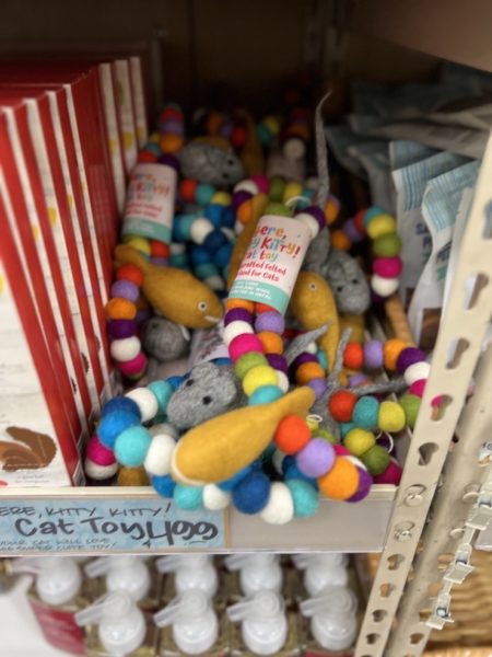 Trader Joe's Felted Wool cat toy on a shelf in a trader joe's store.