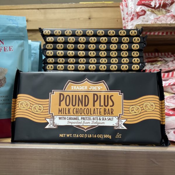 Trader Joe's Pound Plus Chocolate Bar  with Caramel, Pretzel Bits and Sea Salt on display in stores. 
