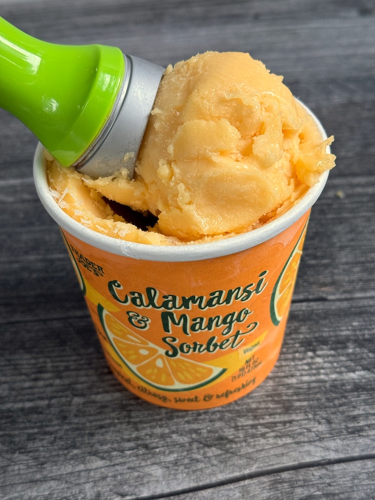Trader Joe's Calamansi & Mango Sorbet scoop on the top of the open container.