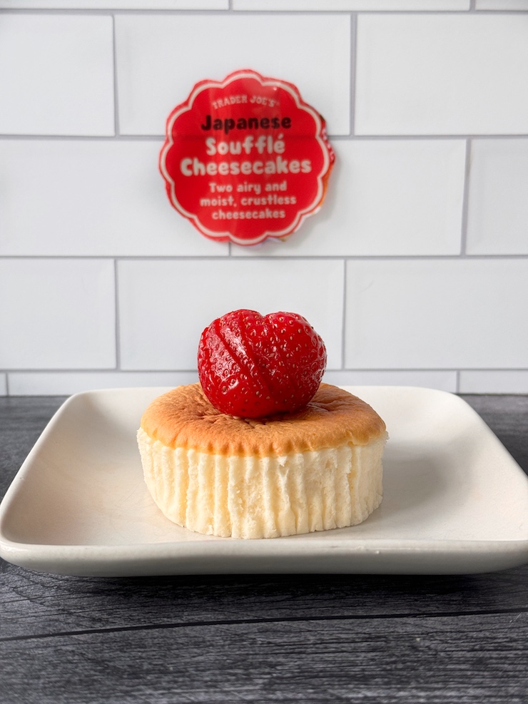 Trader Joe's Japanese Souffle Cheesecake topped with a strawberry on a square white plate.