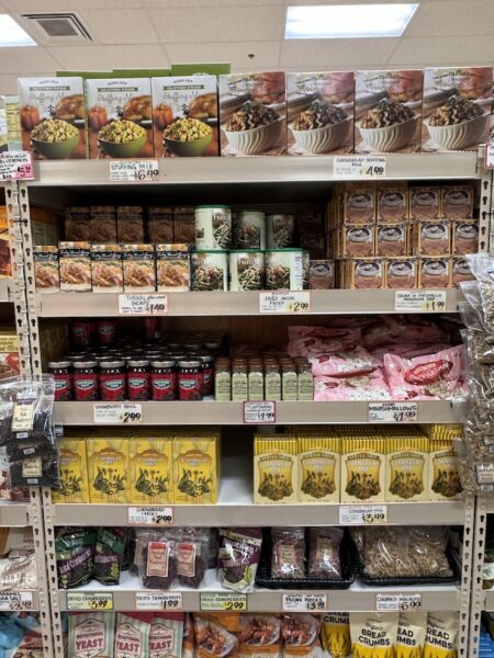 Trader Joe's Thanksgiving Display shelf-stable: Gluten Free Stuffing Mix, Cornbread Stuffing Mix, boxed Turkey Flavored Gravy, French Fried Onions, Cream of Portobello Mushroom soup (box), Cranberry Sauce, Everything But the Leftovers Seasoning, Marshmallows