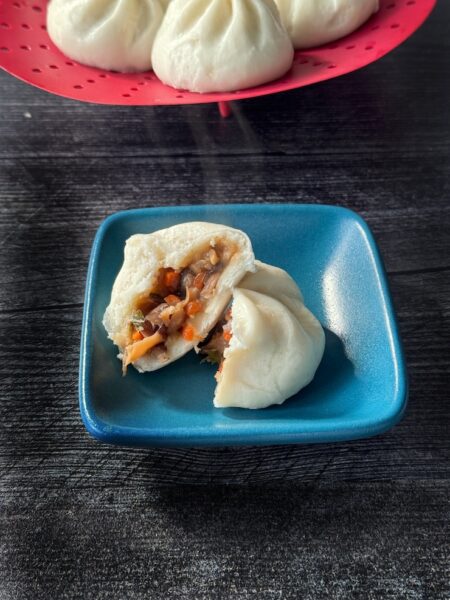 Trader Joe's Teriyaki Mushroom Mini Bao cross section on a square blue plate