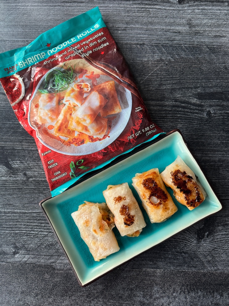 Trader Joe's Shrimp Noodle Rolls bag with 4 rolls on an aqua rectangular plate