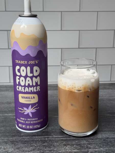 Trader Joe's Cold Foam Creamer with a cup of iced coffee