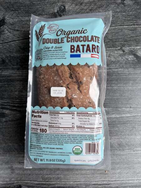 Trader Joe's Double Chocolate Batard in its package on a weathered wood background