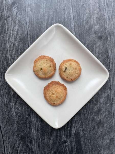 3 Trader Joe's Spicy Cheddar and Jalapeno Biscuit Bites on a square white appetizer plate.