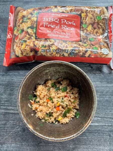 Trader Joe's BBQ Pork Fried Rice in a brown bowl with the package in the background